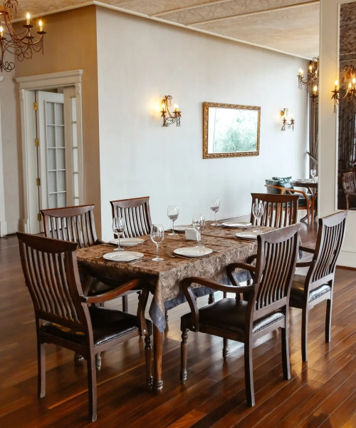 restaurant table with wooden chairs placed in hall decorated in classical style